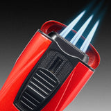 Close-up of the red metallic Monaco cigar lighter by Colibri (Est. 1928), showcasing triple-jet flames, a blue fuel window, and blue light beams streaming from the top against a dark gradient background.